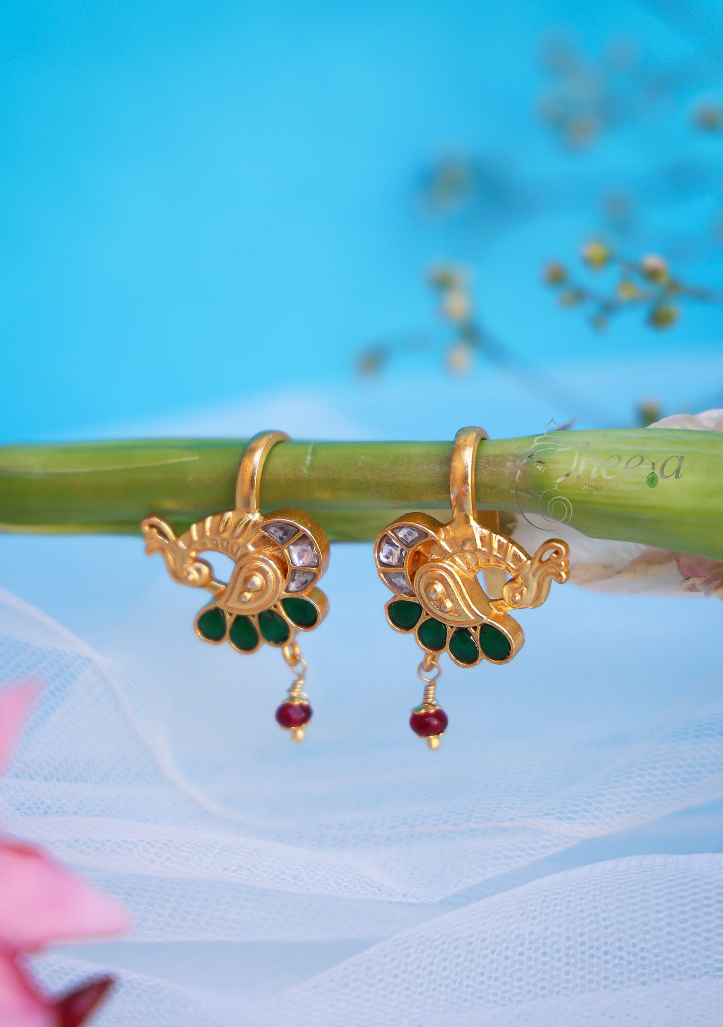 Green stone peacock with red bead bugadi