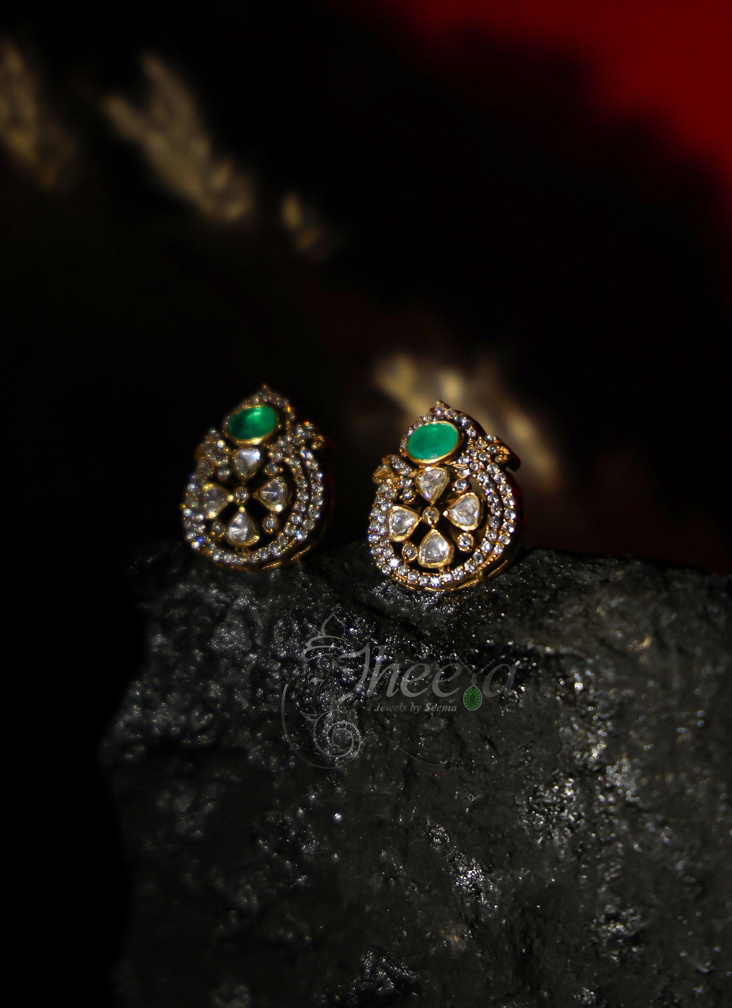 small green stone with moissanaite studs