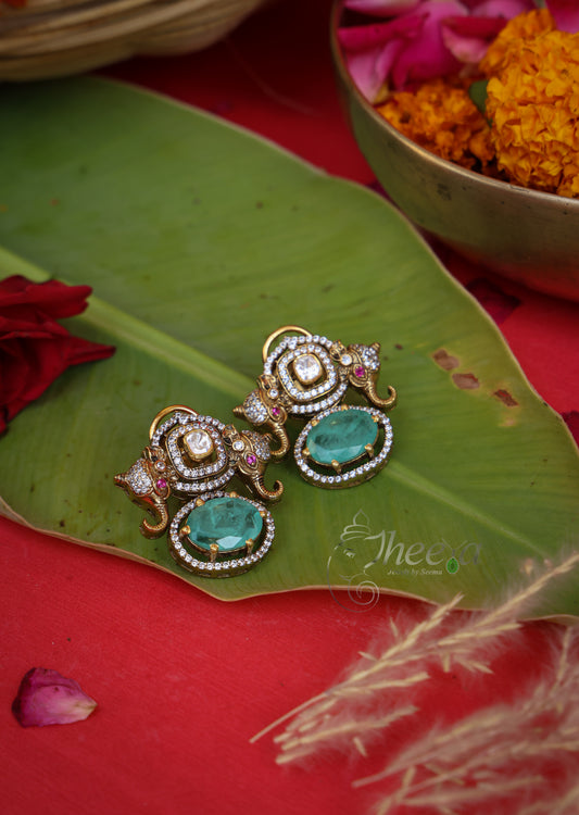 Rajkumari Mini Mint Elephant Studs in Pure Silver with green accents, front view.