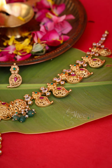 Macro photography highlighting the intricate traditional South Indian antique gold craftsmanship on the Kaveri Gold Necklace.