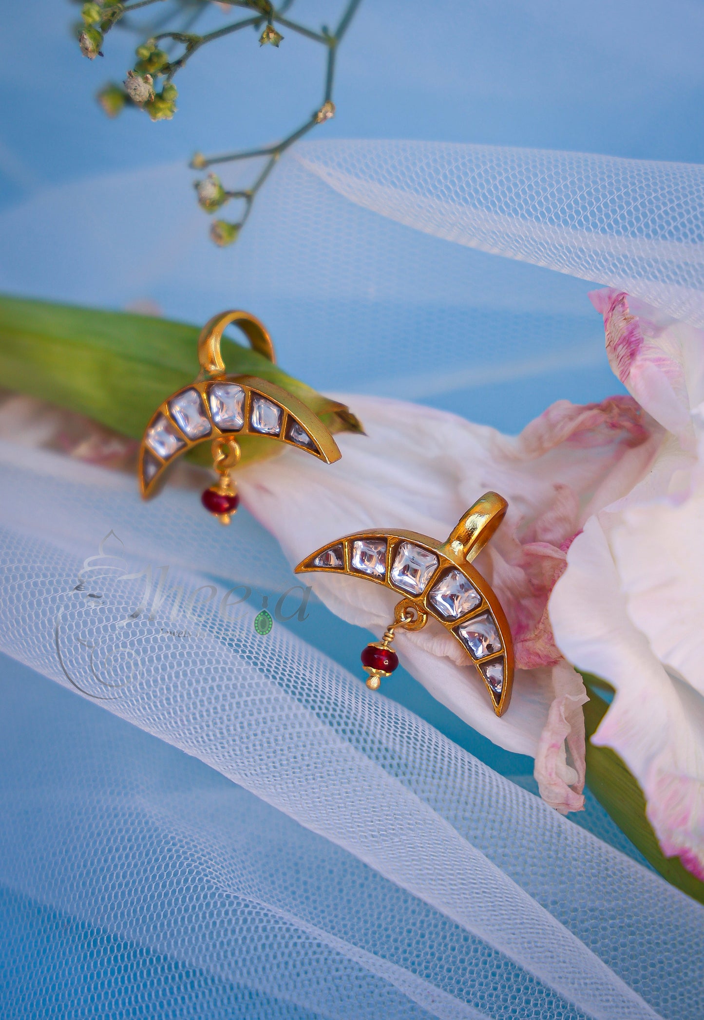 White stone half moon with red drop