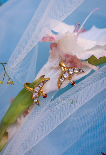 White stone half moon with red drop