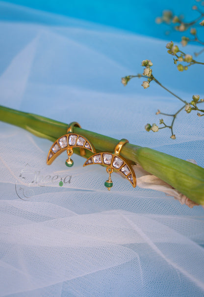 White stone half moon with green drop