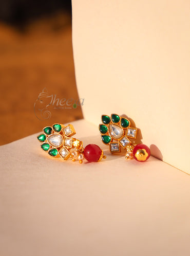 Green and white kundan with red drop