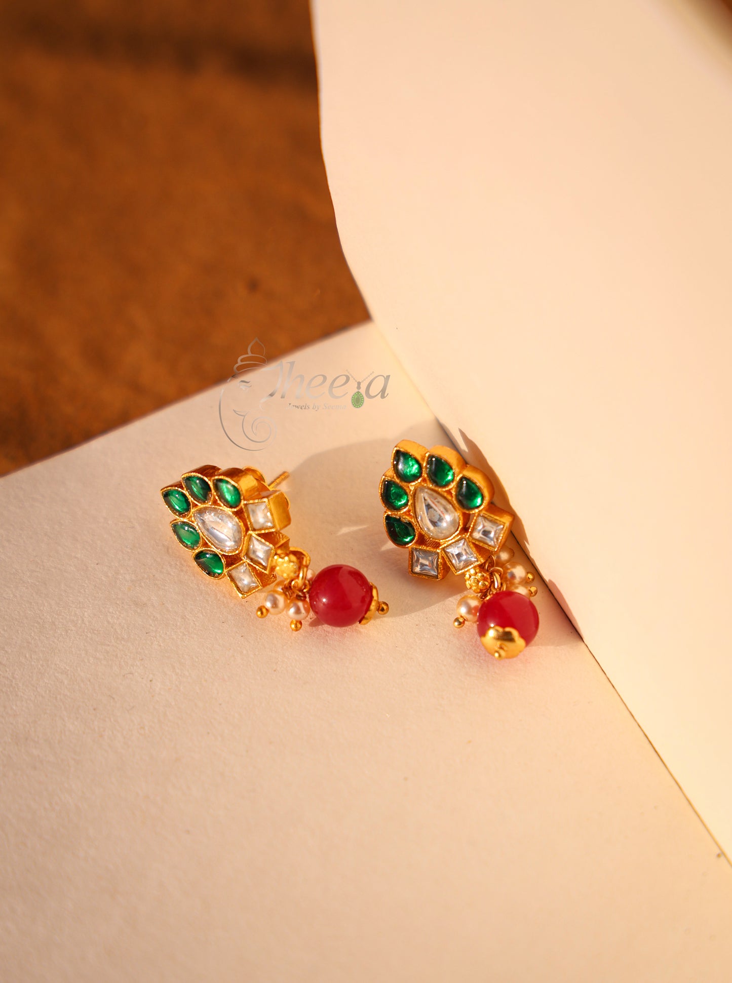 Green and white kundan with red drop