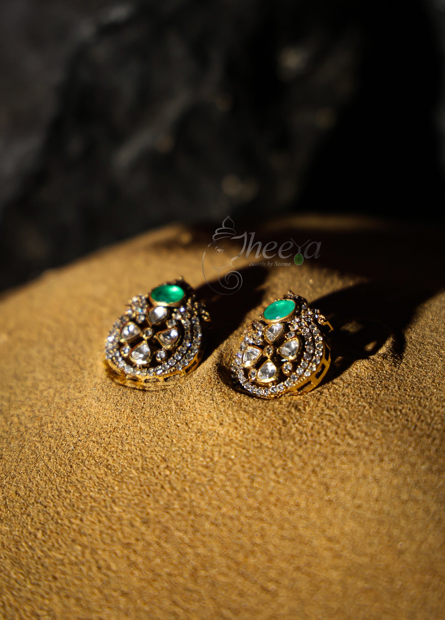 small green stone with moissanaite studs