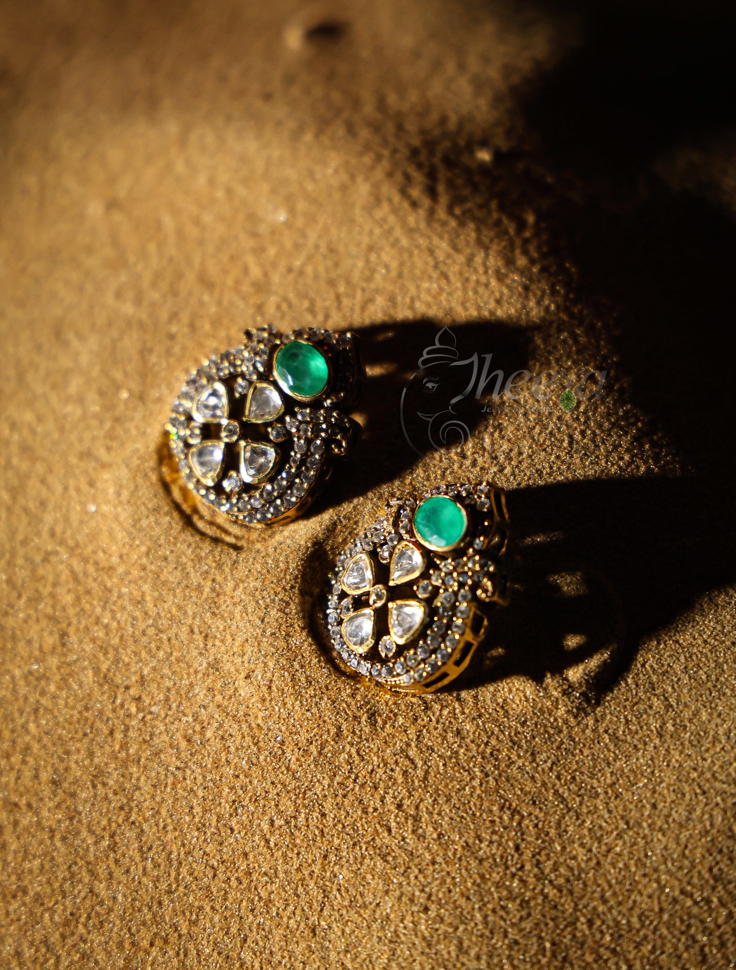 small green stone with moissanaite studs