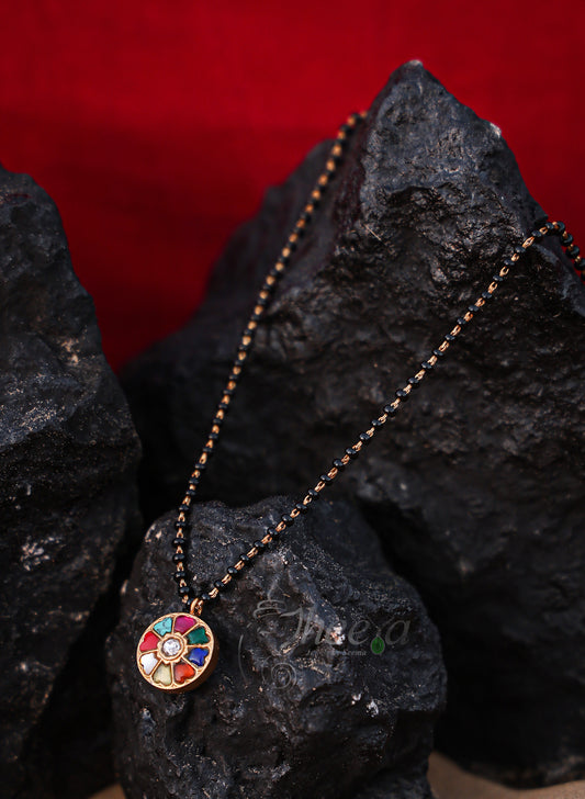 round multi color pendant with black beads