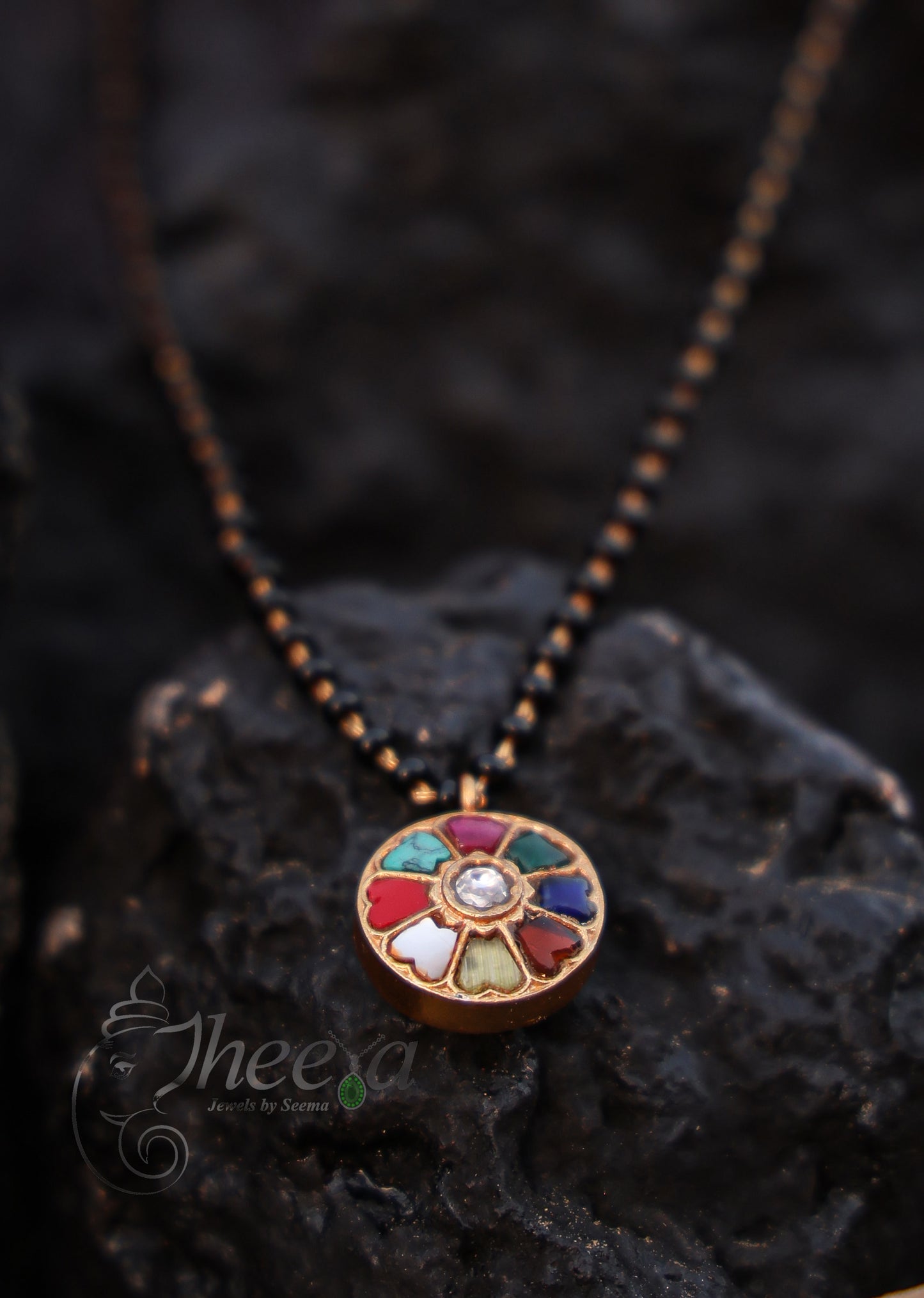 round multi color pendant with black beads