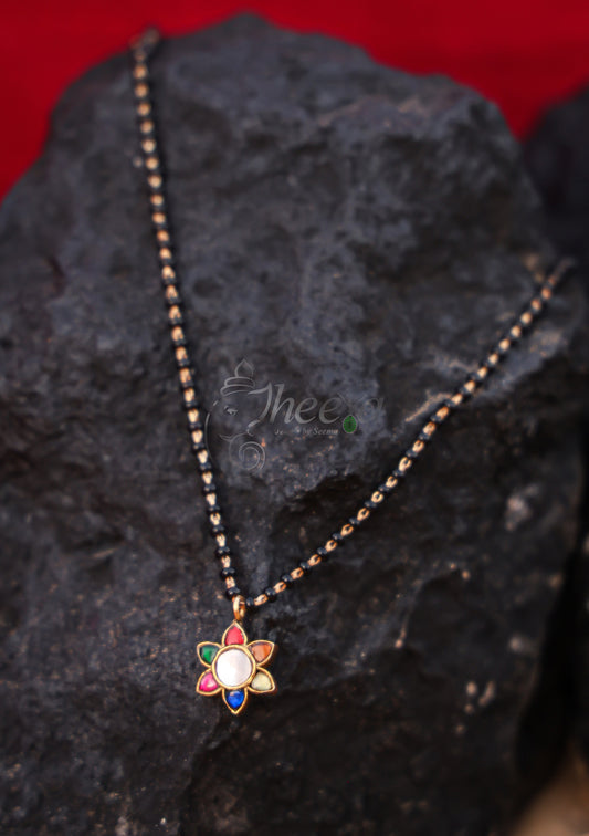 White center multi flower with black beads
