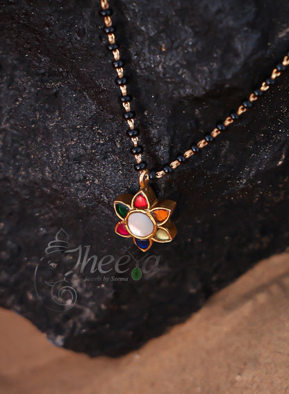 White center multi flower with black beads
