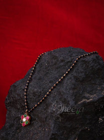 Pink and green flower with black beads