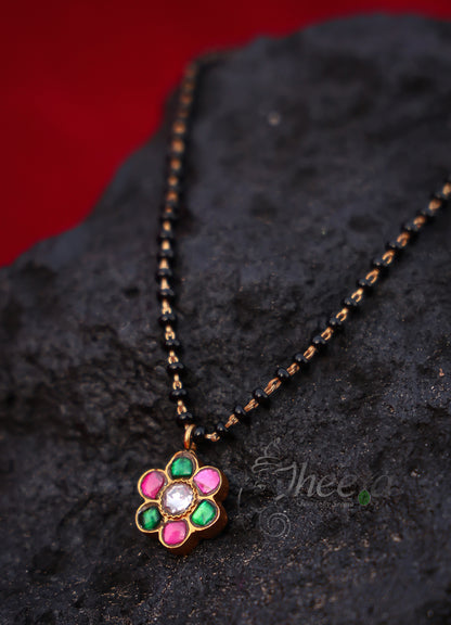 Pink and green flower with black beads