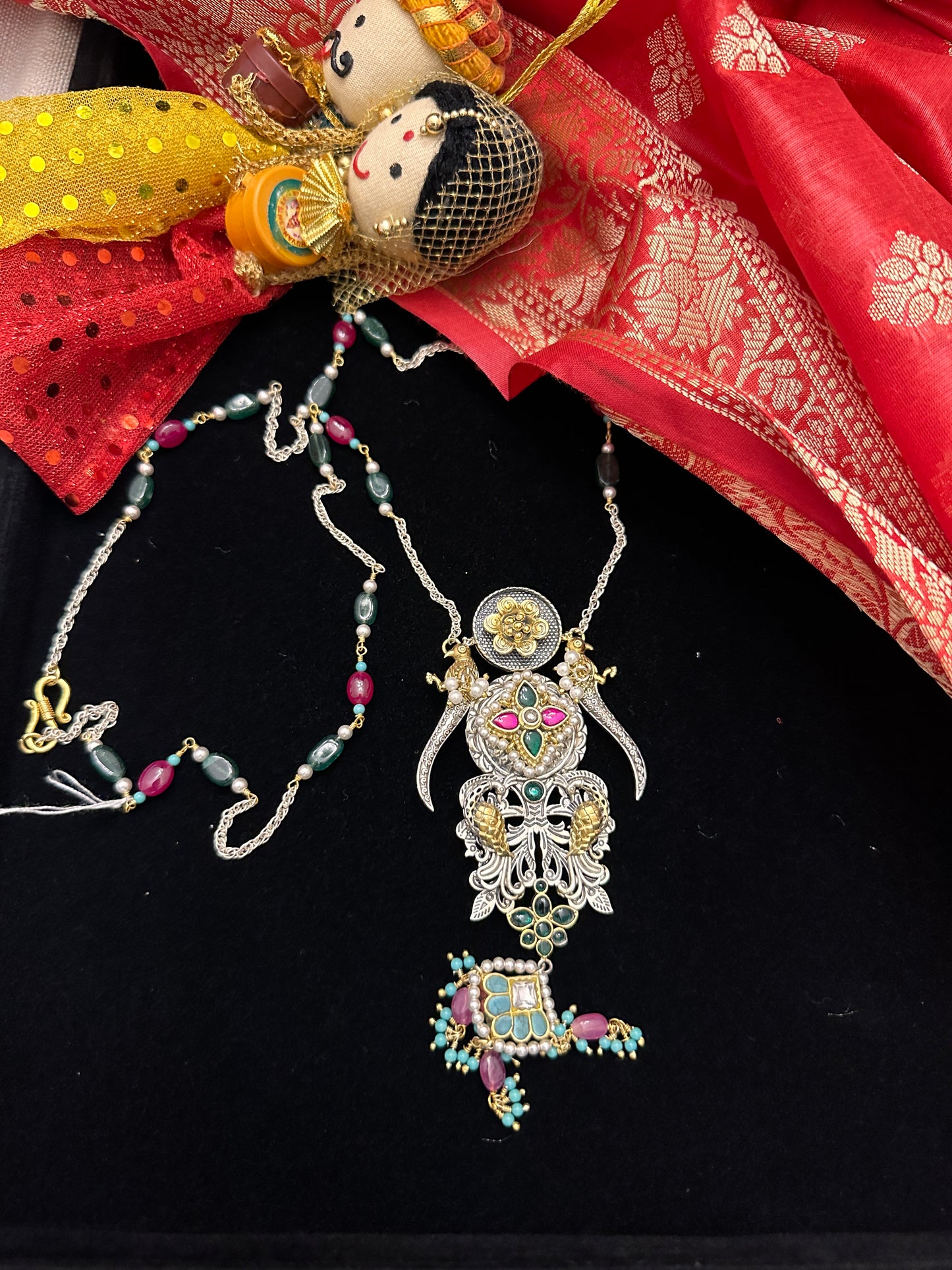 Dual tone peacock pendant with red n green beads