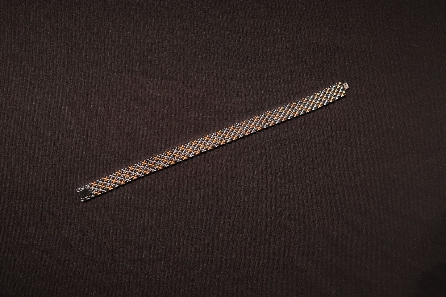Detail shot showing the dual-tone link design of the men's silver bracelet