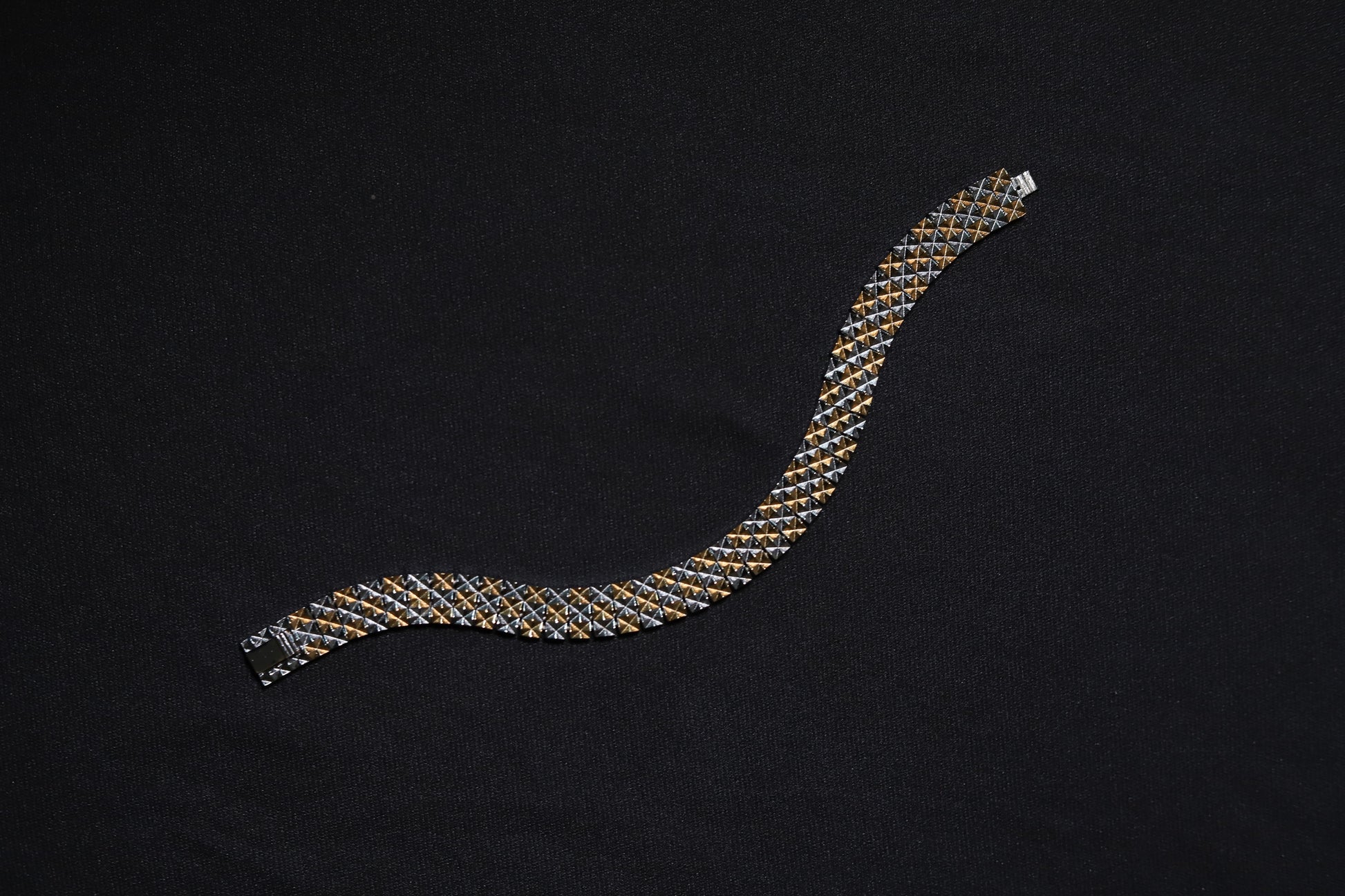 Close-up of pure silver dual-tone checkered men's bracelet on wrist