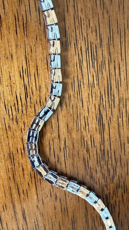 Men's styling featuring the dual tone bracelet with fish hook