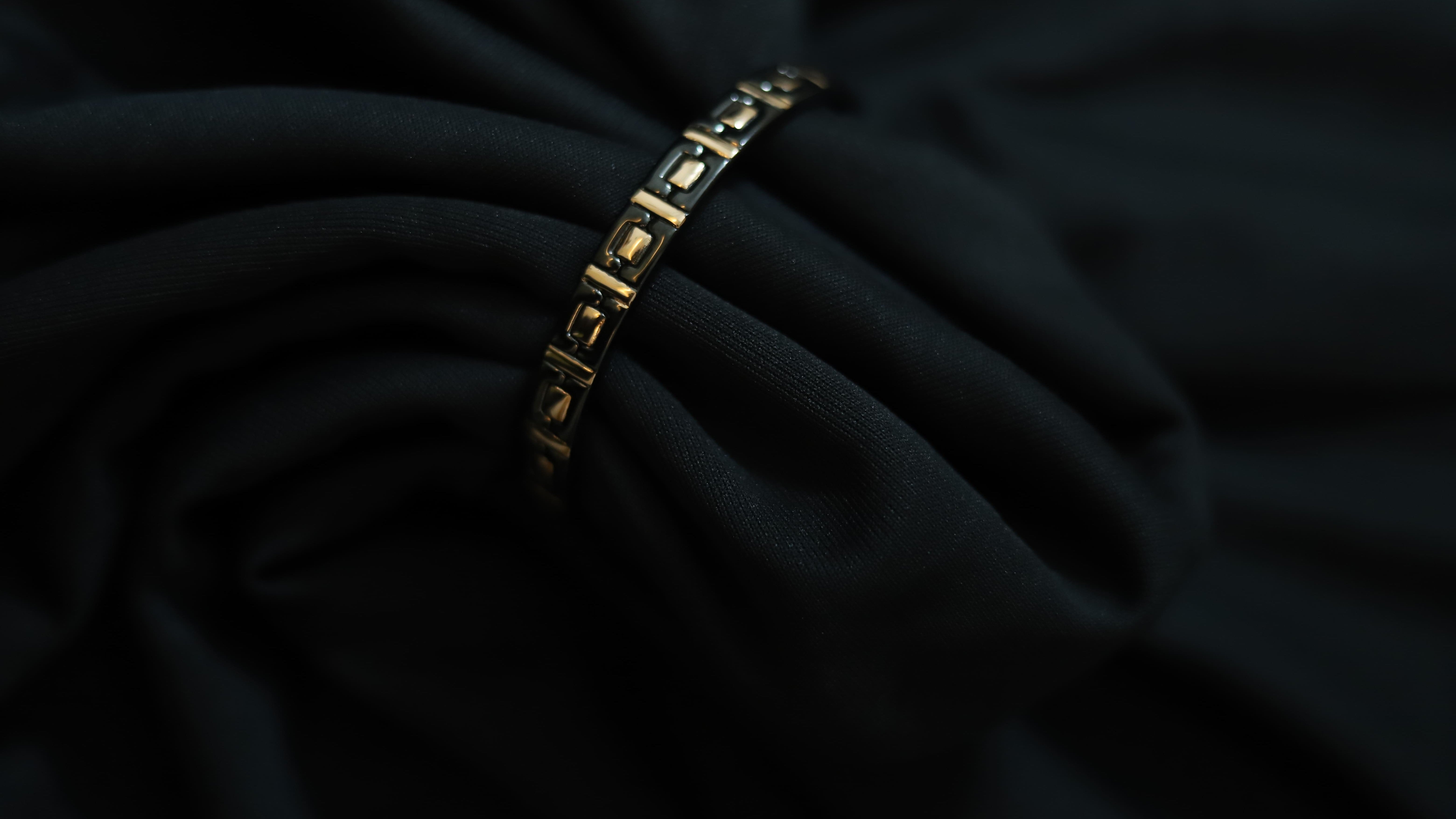 Close-up of pure silver black and rose gold square design on a dark background