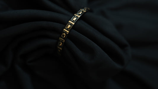 Close-up of pure silver black and rose gold square design on a dark background