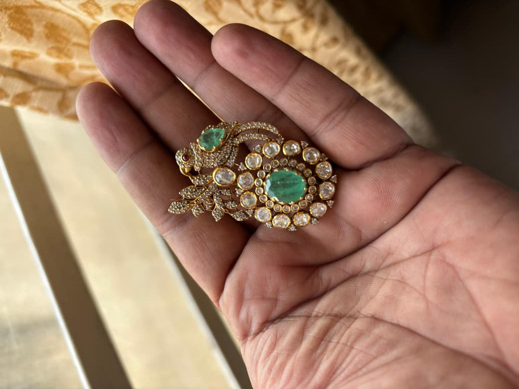 Qasr Green Bird Brooch worn by a model showcasing scale and Brooch design.