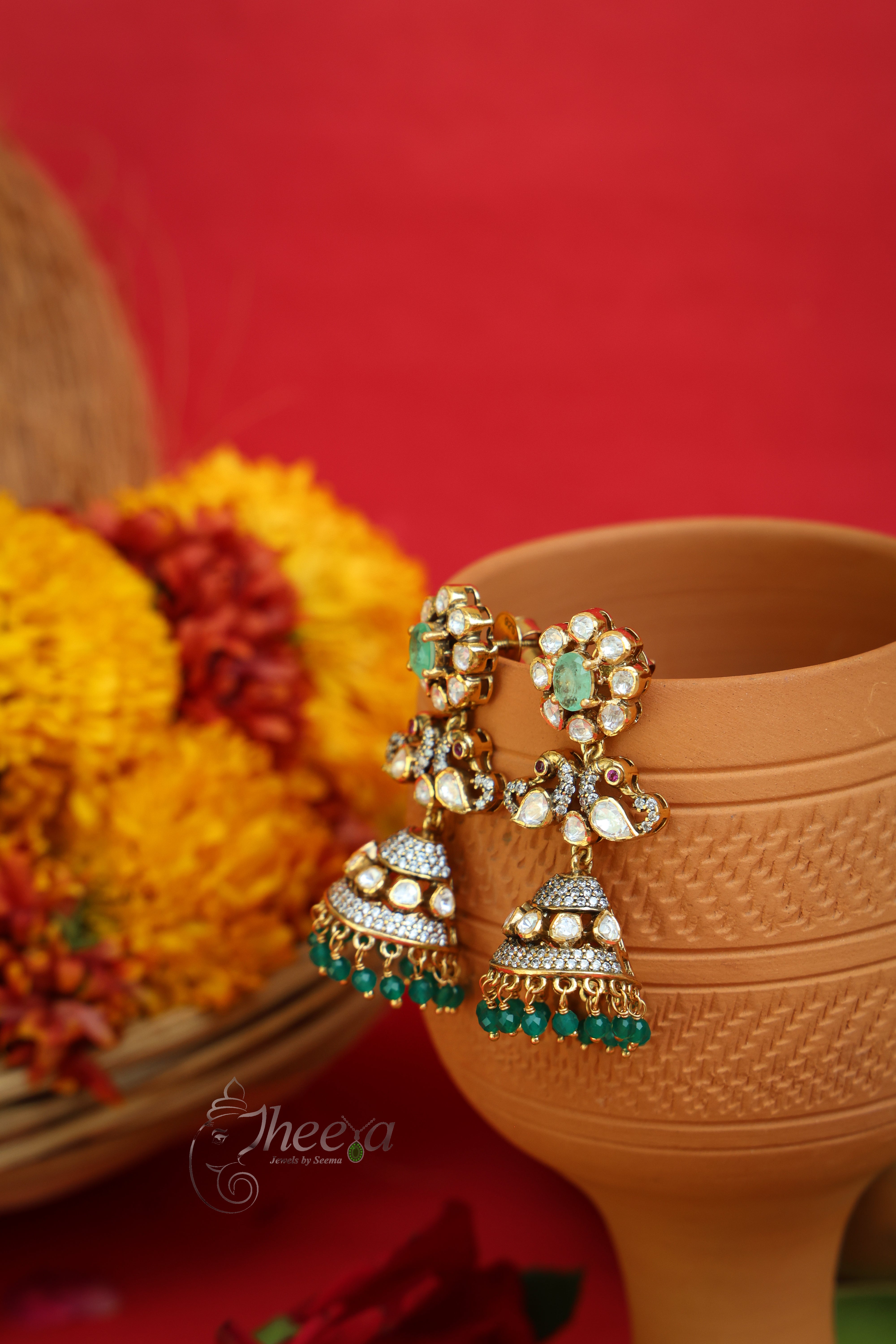 Jiya Studs Mint Flower Jhumkas worn by a model showcasing scale and Earrings design.