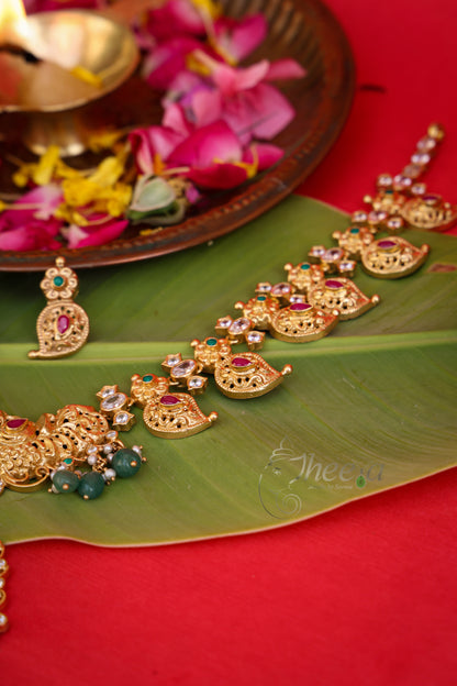 Macro photography highlighting the intricate traditional South Indian antique gold craftsmanship on the Kaveri Gold Necklace.