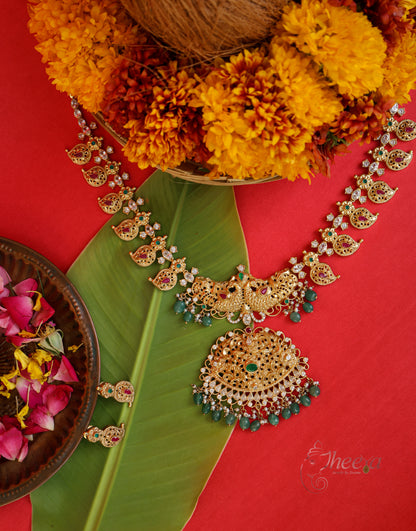 A fashion model wearing the premium Kaveri Gold South Necklace, demonstrating its elegant drape and heavy ethnic styling.