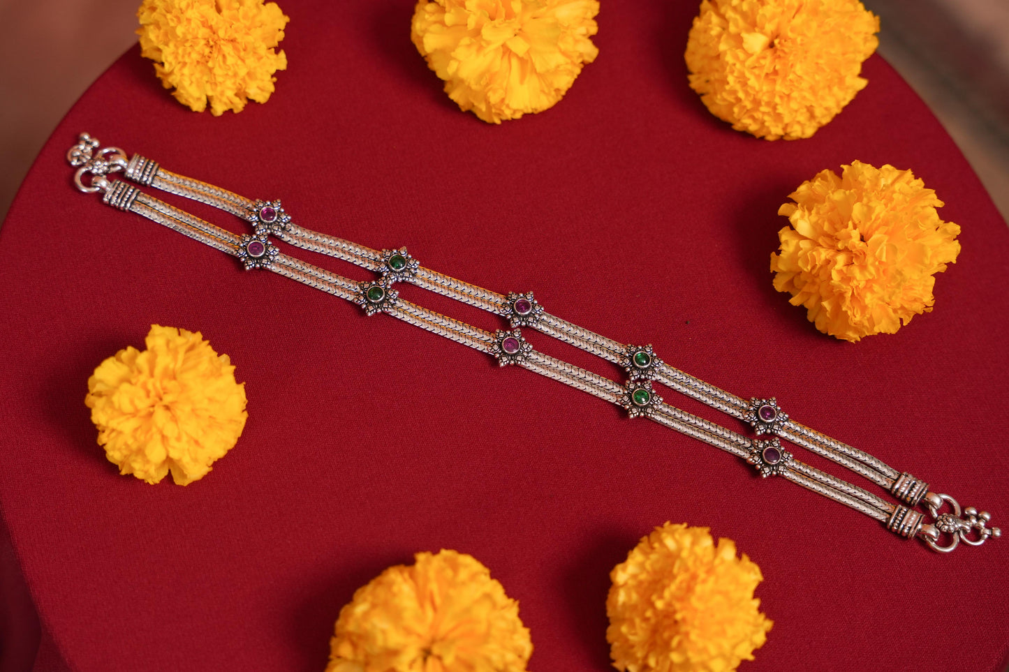 Red and green flowers on double chain anklets