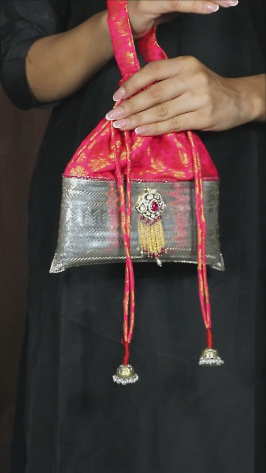 Luxurious pure silver evening potli bag embellished with pink moissanite stones