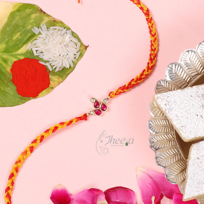Close up of Pure Silver Red and White Paisley Rakhi by Sakshi