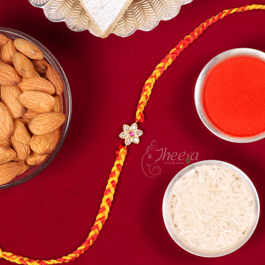 Pure Silver White Flower Rakhi featuring a red stone